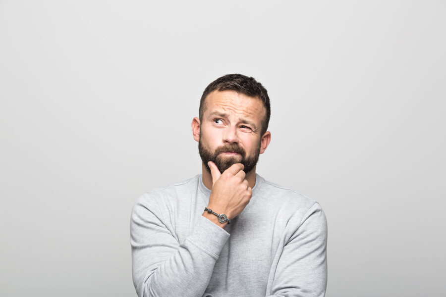 Brunette man with beard and gray shirt wonders if IV sedation is safe in Henderson, NV